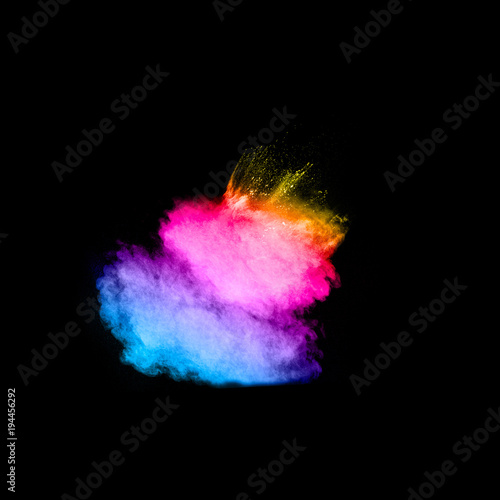 Multicolored powder explosion cloud isolated on black background. Freeze motion of color dust particles splash.