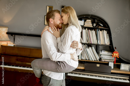Loving couple kissing in the room