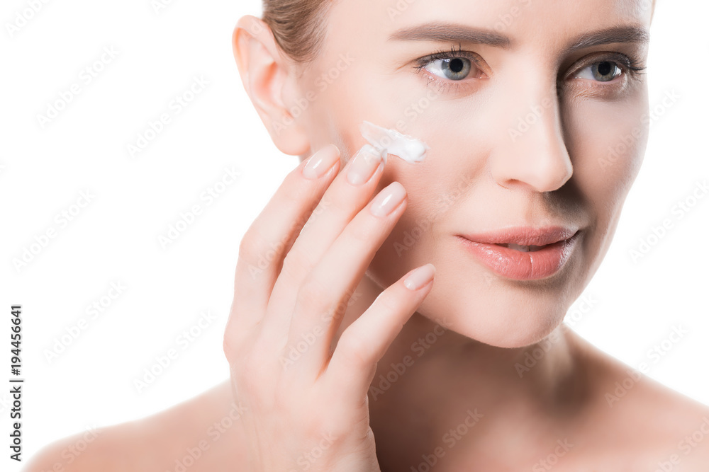 Female applying cream on face isolated on white Female applying cream on face isolated on white