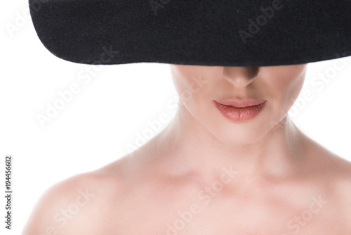 Woman with partly hidden face under hat isolated on white