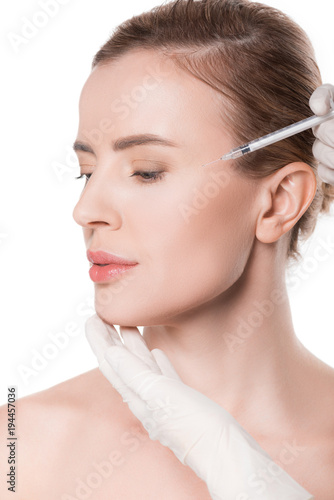 Beautician hands doing injection in woman cheek isolated on white