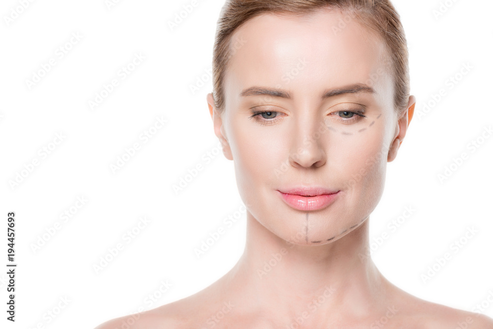 Woman with painted lines on face for plastic surgery isolated on white Woman with painted lines on face for plastic surgery isolated on white