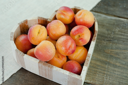 Peaches ripe fresh fruit in a heart shaped bowl