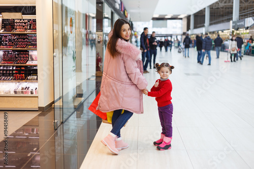 Mom and daughter make purchases together.