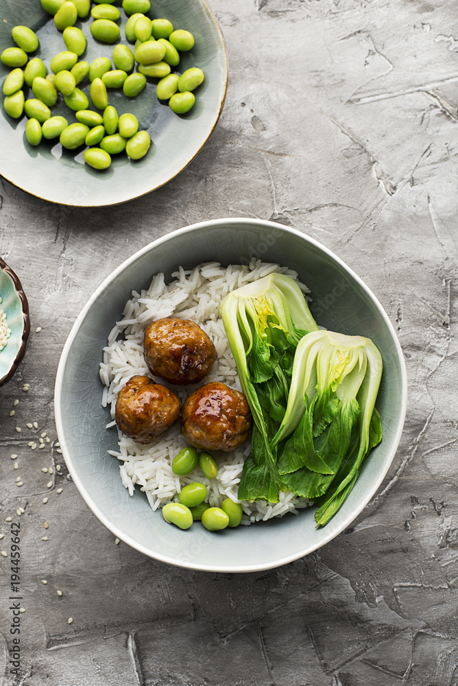 Healthy home cooking. Meat balls teriyaki, rice, cabbage bok choy bowl with sesame seeds in a ceramic dish. Top View. Healthy home cooking. Meat balls teriyaki, rice, cabbage bok choy bowl with sesame seeds in a ceramic dish. Top View.