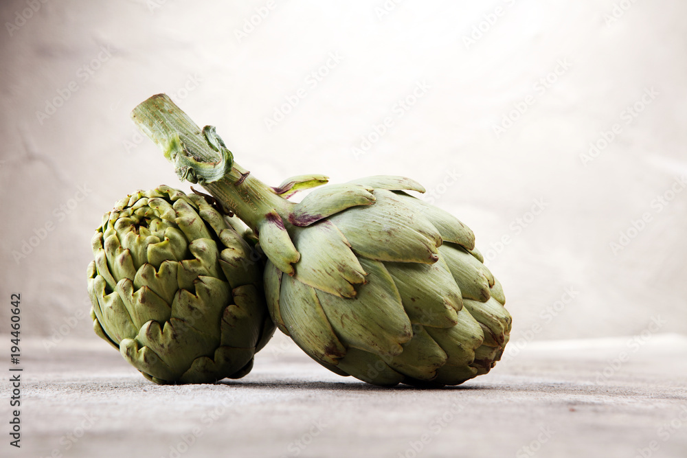 Fototapeta premium artichokes on grey background. fresh organic artichoke flower.