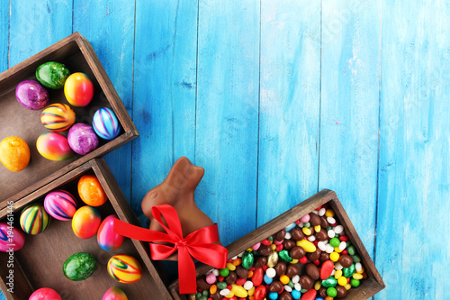 Chocolate Easter eggs and chocolate bunny and colorful sweets.