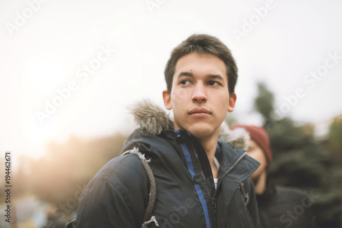 Portrait of an handsome dreaming serious young adult man looking up in sky