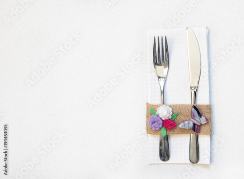 white napkin  knife and fork  place for dinner served in rustic style