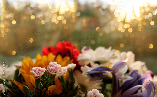 Flowers background with bokeh effect. Selective focus, copy space. Bright bouquet, sunny lights.