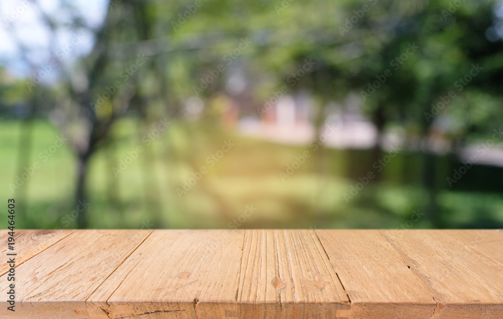 image of wooden table in front of abstract blurred background of outdoor garden lights. can be used for display or montage your products.Mock up for display of product image of wooden table in front of abstract blurred background of outdoor garden lights. can be used for display or montage your products.Mock up for display of product