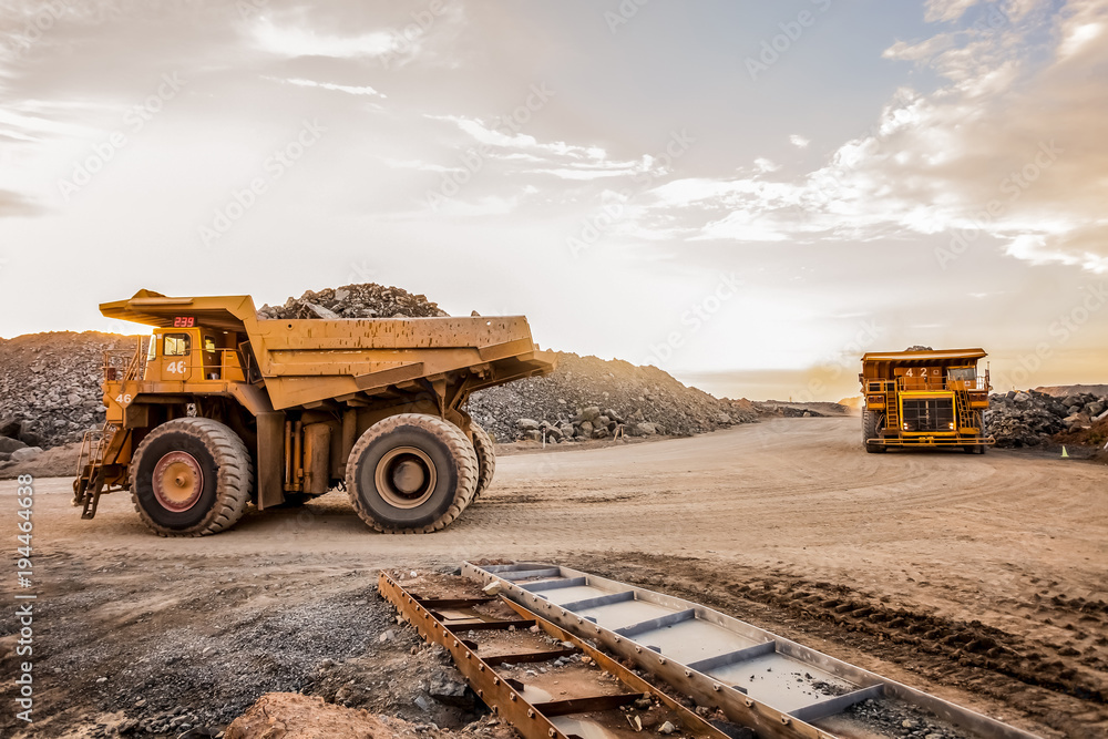 Konstfotografi Mining dump trucks transporting Platinum ore for processing