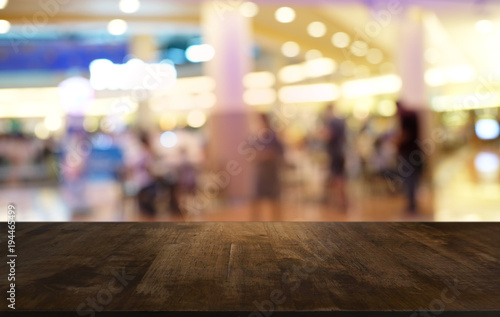 Empty wood table top and blur of night market background/selective focus .For montage product display. © Charlie's