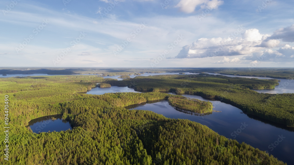 Aerial view of blue lakes and green forest in Finnish national park at summer