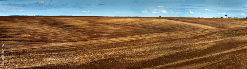 Fototapeta premium Lines of arable land landscape panorama