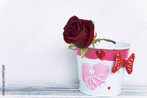 red rose in decorative bucket background