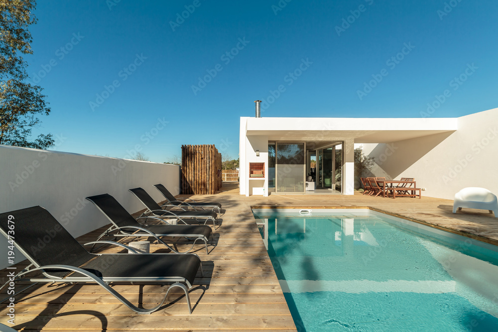 Fototapeta premium Modern house with garden swimming pool and wooden deck