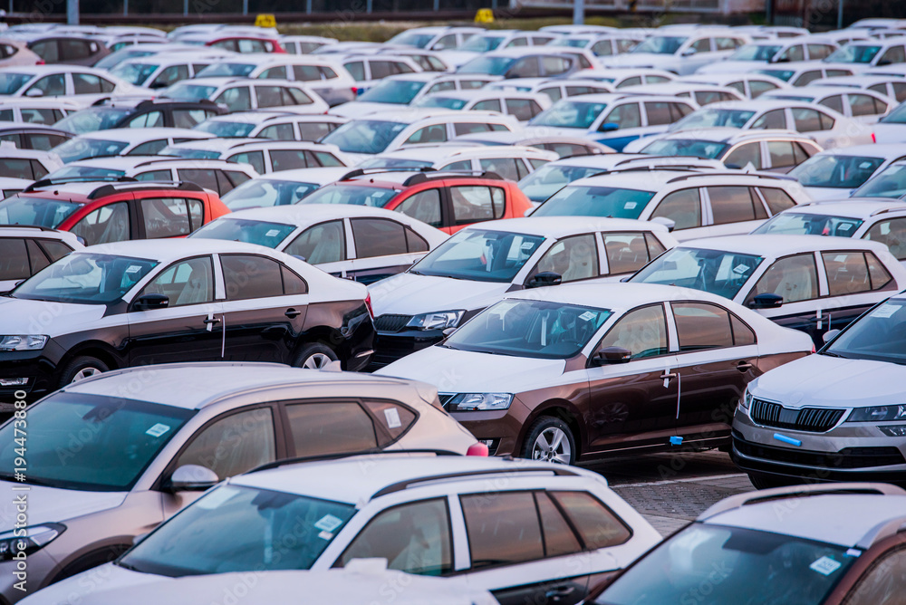 Many new cars parked in a row, ready for export Many new cars parked in a row, ready for export