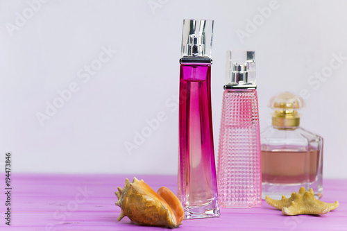 perfume on a pink wooden board