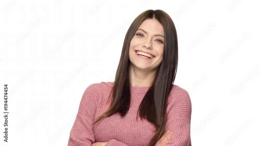 Portrait of amazing mature woman 30s in pink sweater posing at camera with pleasant and seductive look, isolated over white background in studio. Concept of emotions Portrait of amazing mature woman 30s in pink sweater posing at camera with pleasant and seductive look, isolated over white background in studio. Concept of emotions