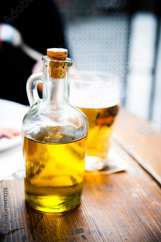 Olive oil in a glass bottle on a table
