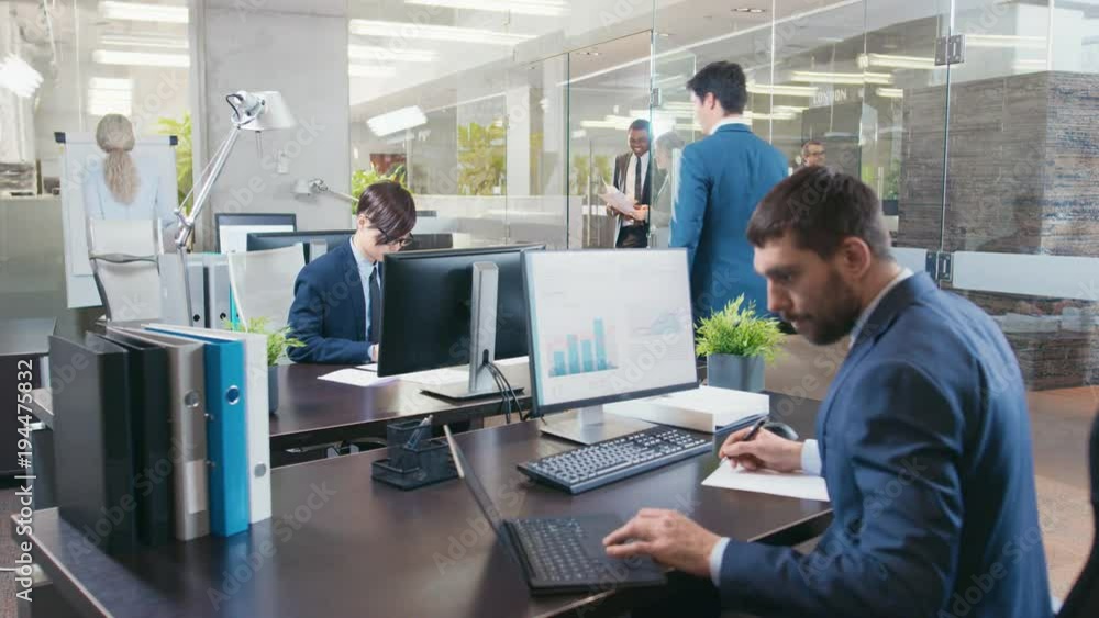 Diverse Team of Businessmen and Businesswoman Working at Their Desktops in the Modern Office. They have Discussions, Work With Papers and Do Business Professionally. Shot on RED EPIC-W 8K. Diverse Team of Businessmen and Businesswoman Working at Their Desktops in the Modern Office. They have Discussions, Work With Papers and Do Business Professionally. Shot on RED EPIC-W 8K.