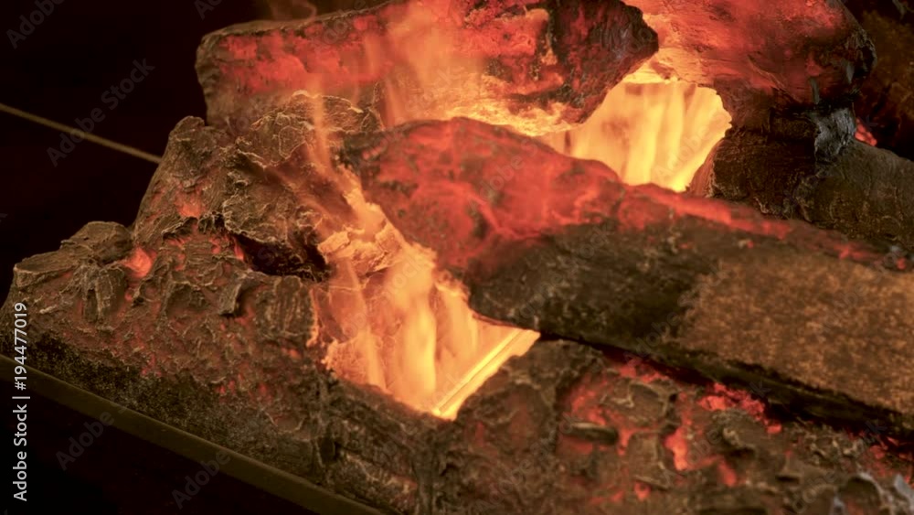 Home interior. Close-up shot of warm cozy burning fire in a electric fireplace. 4K Home interior. Close-up shot of warm cozy burning fire in a electric fireplace. 4K