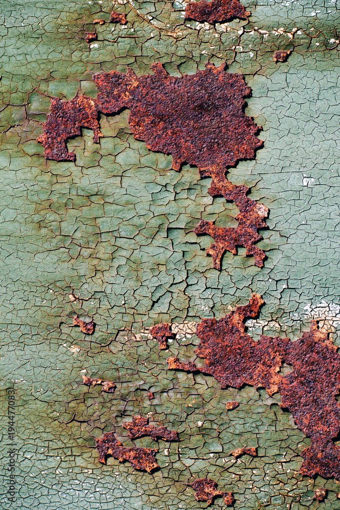 Rusty metal surface with cracked green paint, abstract rusty metal texture, rusty metal background for design with copy space, corrosion