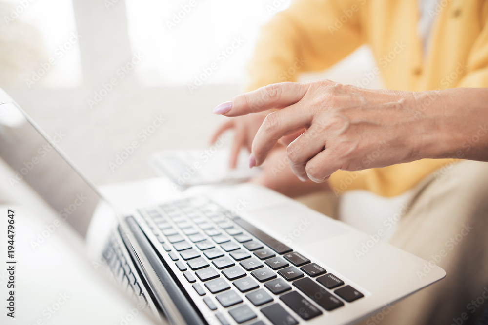 Close up. A pair of old people are sitting in front of a laptop. They found the home of their dreams. Close up. A pair of old people are sitting in front of a laptop. They found the home of their dreams.