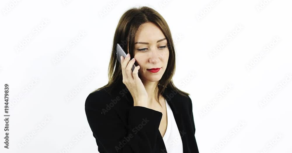 Young business woman in black jacket is talking on mobile phone and smiling. Young business woman in black jacket is talking on mobile phone and smiling.