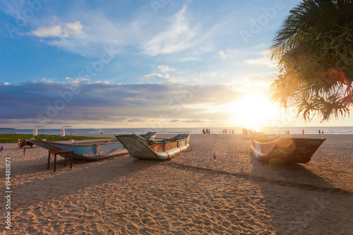 Ahungalla, Sri Lanka - Traditional longboats drying at Ahungalla Beach during sunset