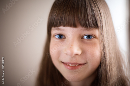 little girl with freckles and blue eyes smiling