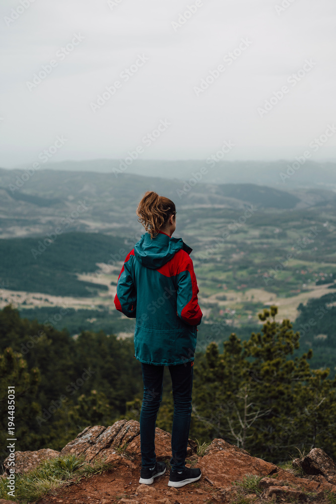 Woman enjoy the view from the mountain peak Woman enjoy the view from the mountain peak