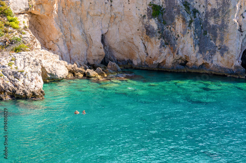 People swimming in the crystal clear water. Porto Limnionas beach on the island of Zakynthos. Greece. © vivoo