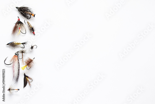 A lot of fishing flies on white Background