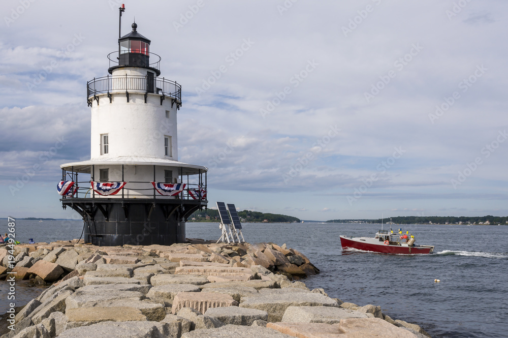 Lobster Boat Passes by Spring Point Lighthouse in Maine.