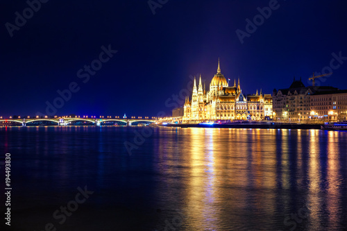 Night view of illuminated Budapest with Danube river, parliament, and bridge, Hungary.