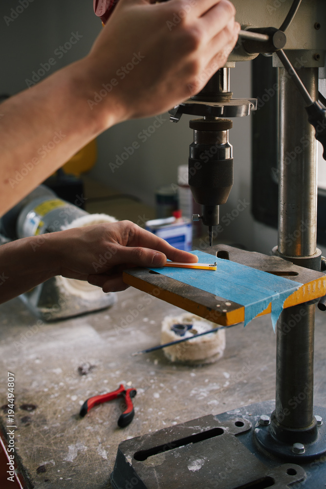 Close up of unrecognizable artisan working with drill machinery in the atelier Close up of unrecognizable artisan working with drill machinery in the atelier
