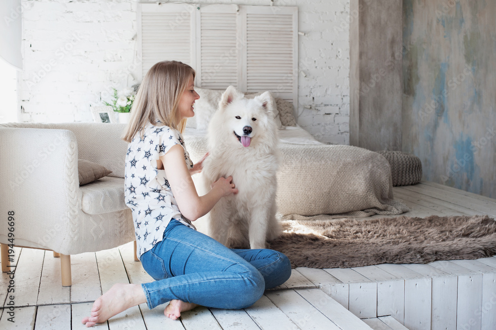 Young woman with cute dog at home Young woman with cute dog at home