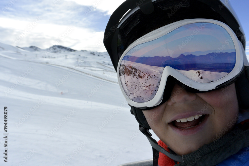 Happy cute boy in ski goggles is going up the mountain on a ski lift Stock  Photo | Adobe Stock