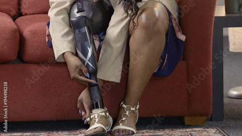 Black female amputee putting on her shoes