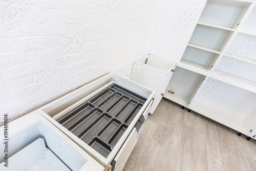 Stacks and rows of grey plastic cutlery tray easy to fit in kitchen drawer for sorting spoon fork