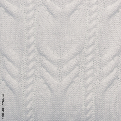 Knitted background. Knitted white texture. A knitting pattern of wool. Knitting. Background.
