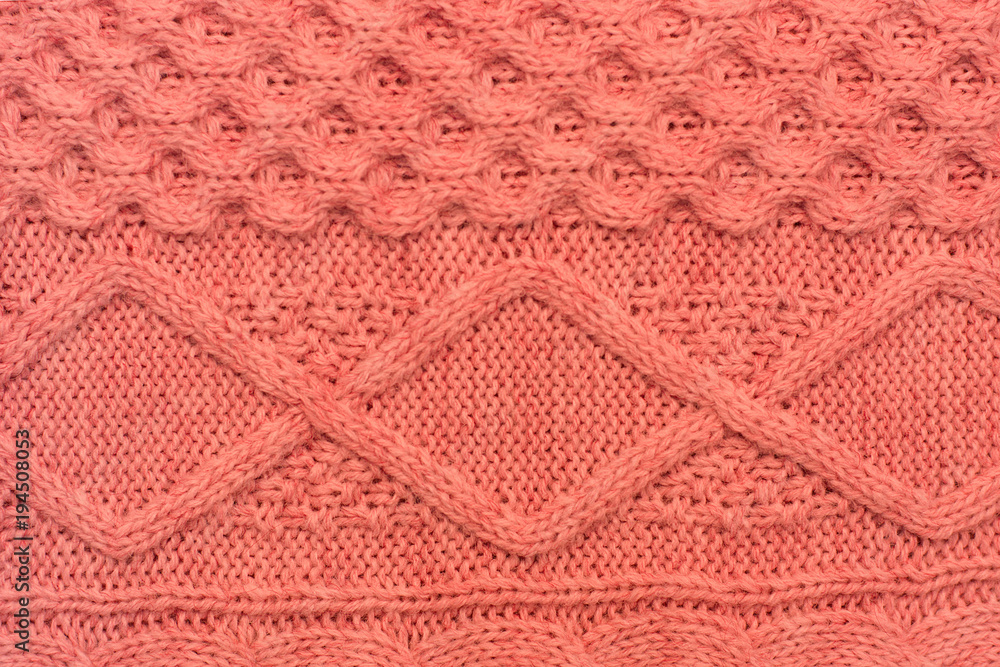 Knitted background. Knitted pink texture. Knitting pattern of wool. Knitting. Background.