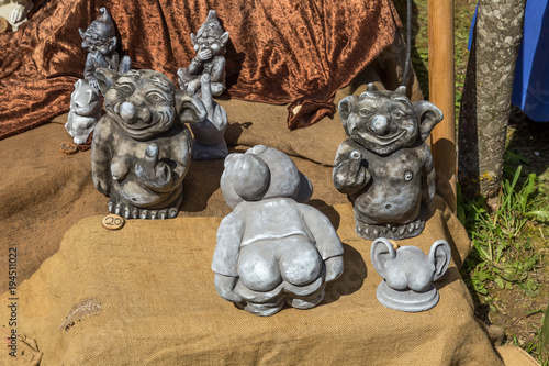 Funny statues doing obscene offensive immoral gesture as showing the middle finger and ass butt