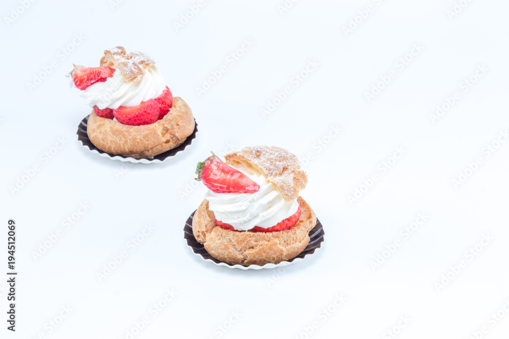 Chou aux fraises - Tart with strawberries and whipped cream. Side view on white background Chou aux fraises - Tart with strawberries and whipped cream. Side view on white background