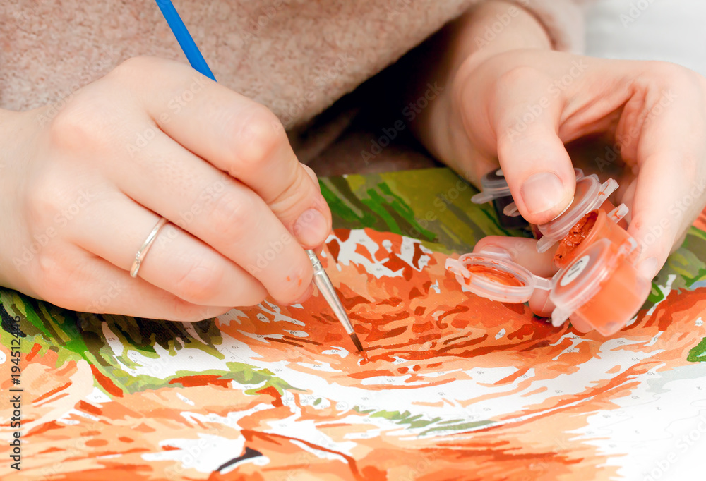 Young woman painting by numbers Young woman painting by numbers