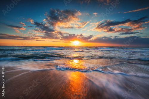Sunrise over the sea and beautiful cloudscape © ValentinValkov