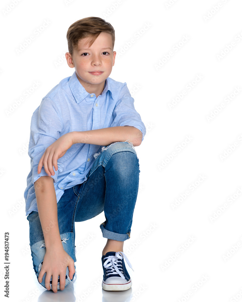 Fototapeta premium Fashionable boy teen sitting on the floor.