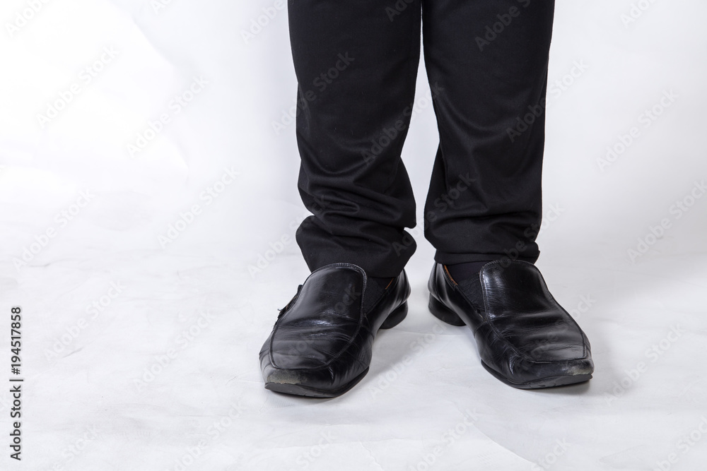 shoes and legs of a businessman caution step